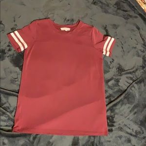 Maroon t shirt with white stripes on sleeves